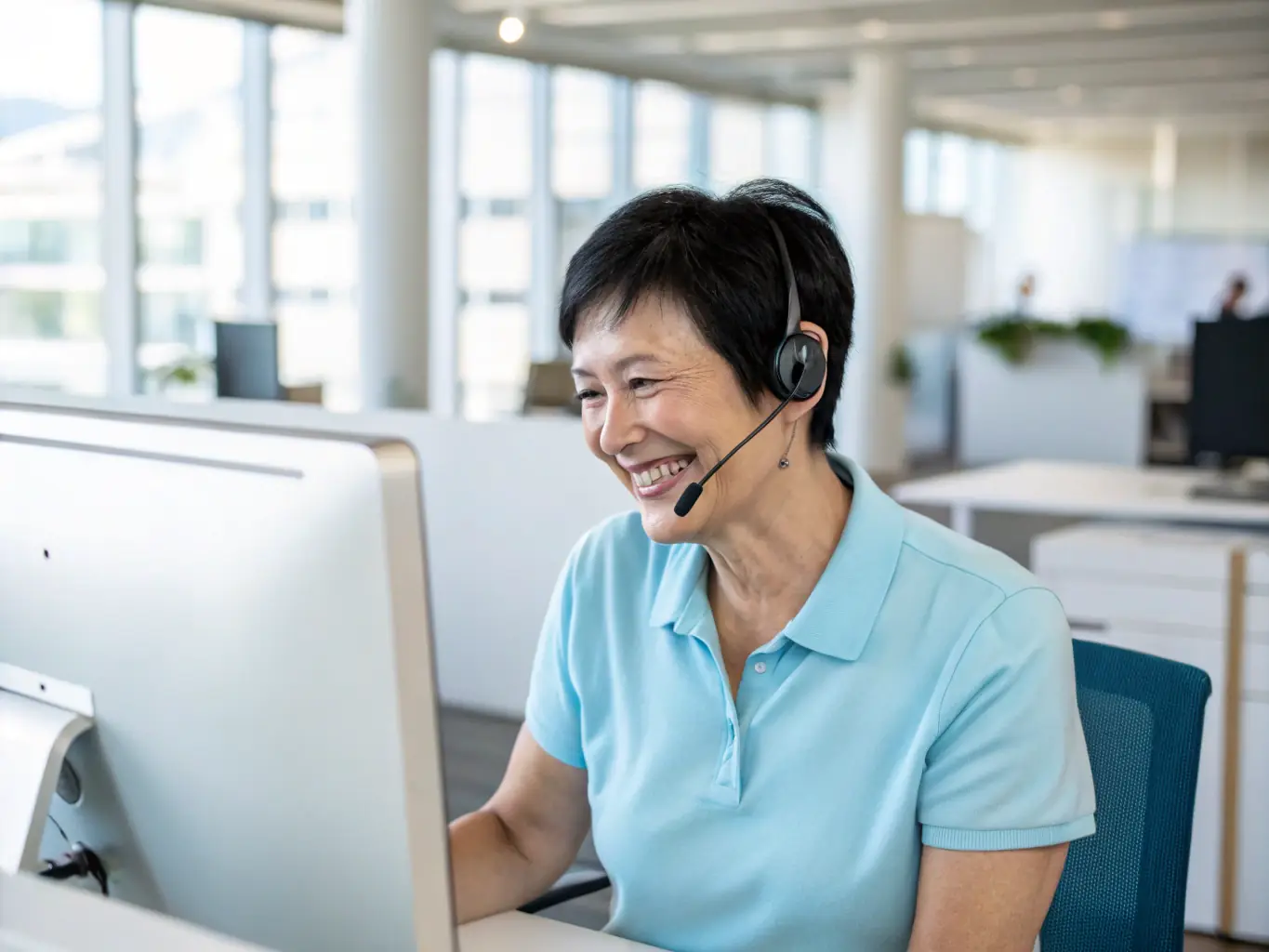 A person providing support to a customer over the phone, showcasing the communication and problem-solving skills required for a career in customer service. The setting is a bright and friendly call center.